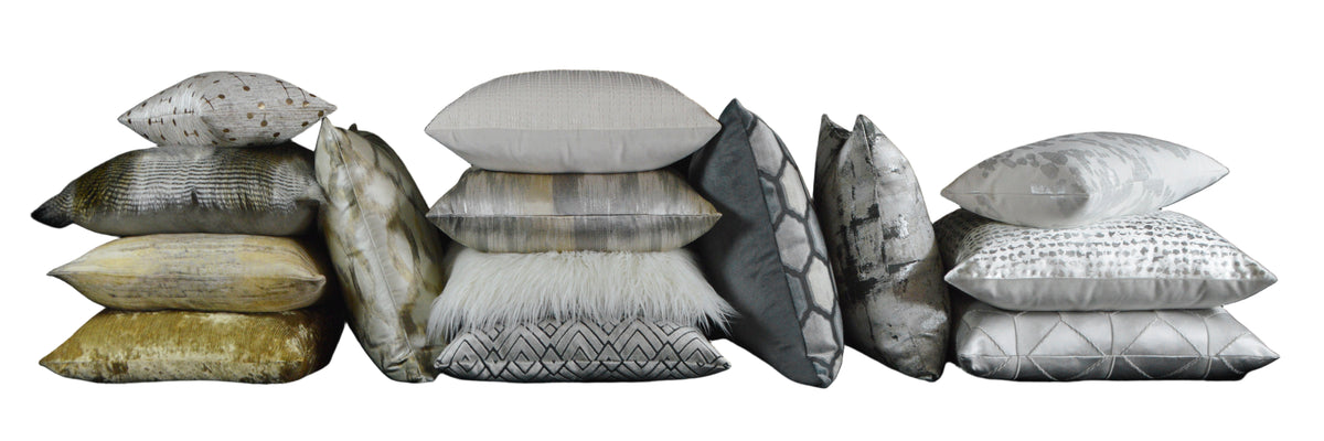Collection of various textured pillows on a black background