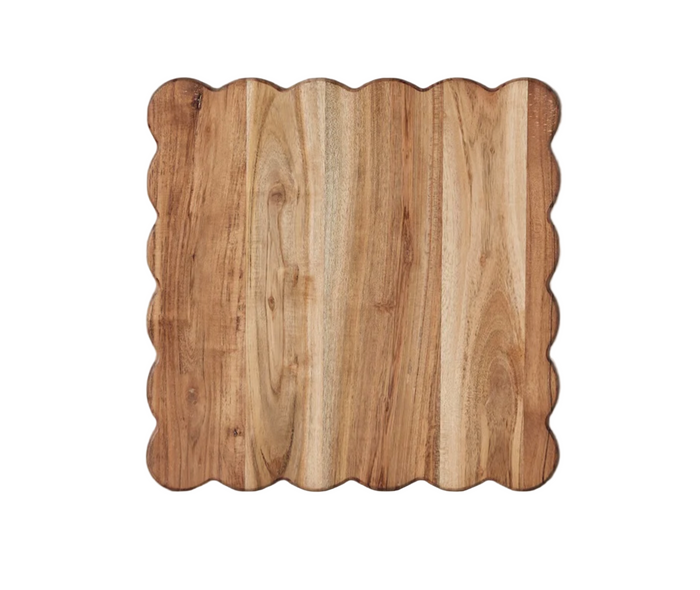 Wooden cutting board with scalloped edge on a white background